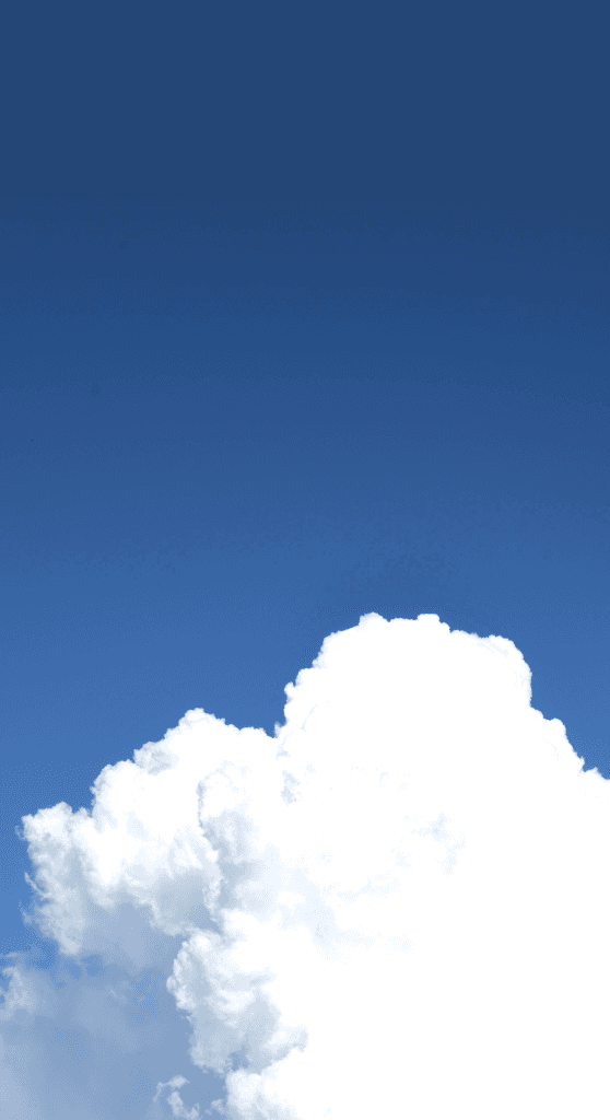 Clear azure sky with a soft cumulus cloud in the lower horizon