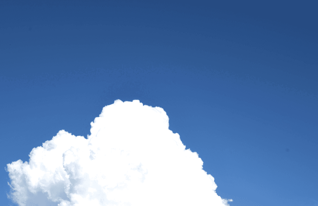 Clear azure sky with a soft cumulus cloud in the lower horizon
